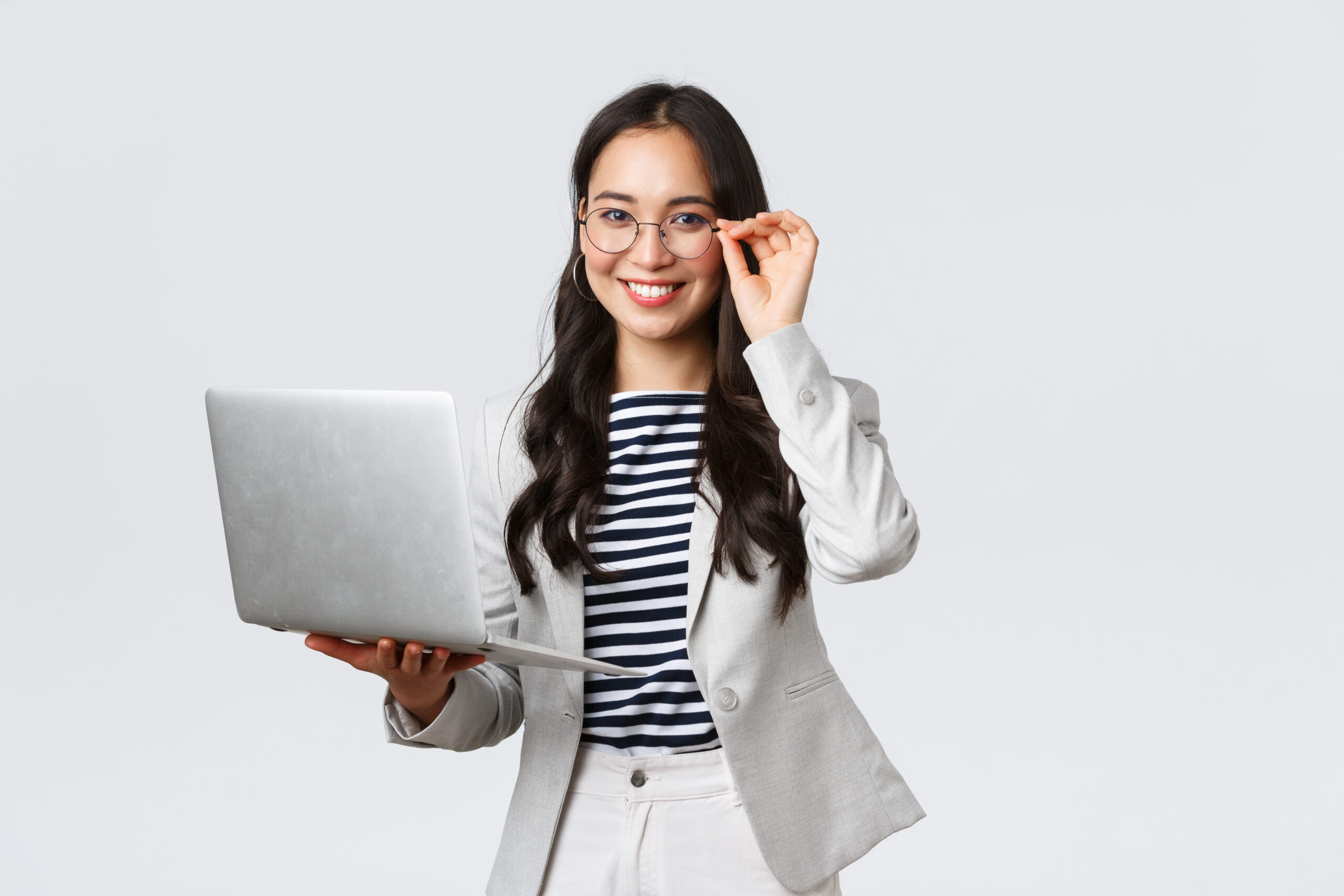 Business, finance and employment, female successful entrepreneurs concept. Confident smiling asian businesswoman, office worker in white suit and glasses using laptop, help clients.