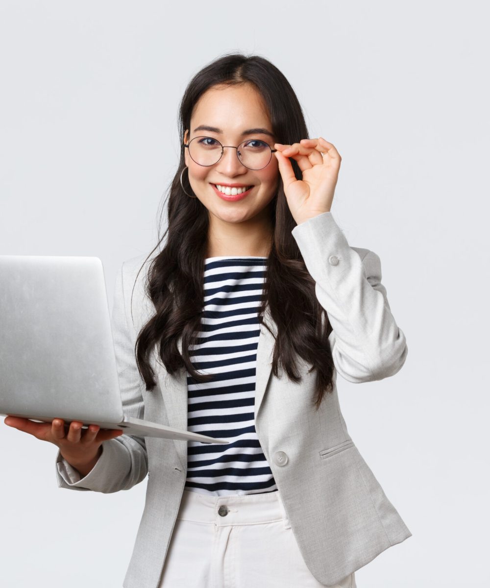 Business, finance and employment, female successful entrepreneurs concept. Confident smiling asian businesswoman, office worker in white suit and glasses using laptop, help clients.